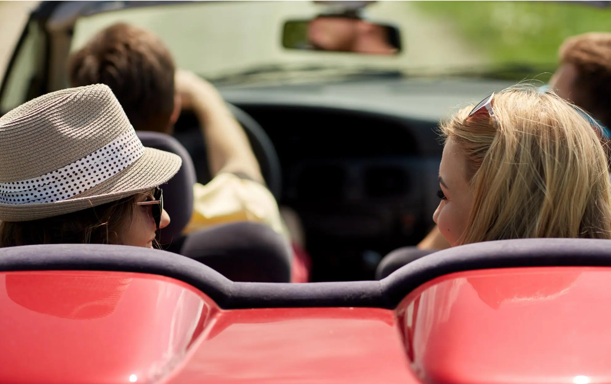 women sit on the red car back seat